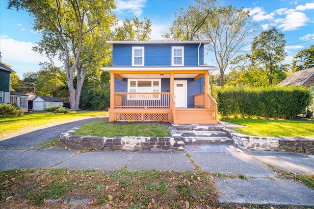 front facade with a front lawn and a porch