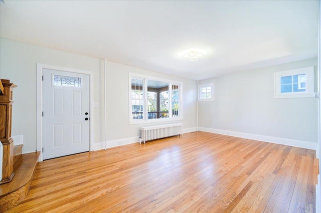 entrance foyer with radiator and light wood-type flooring