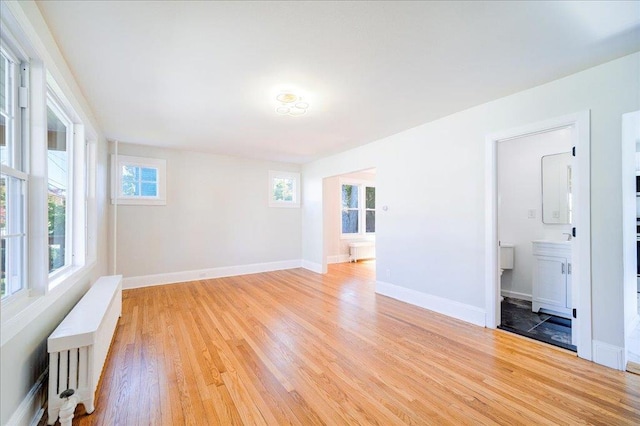 empty room featuring light hardwood / wood-style floors and radiator