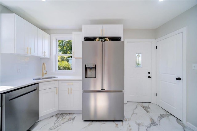 kitchen with white cabinetry, sink, and appliances with stainless steel finishes