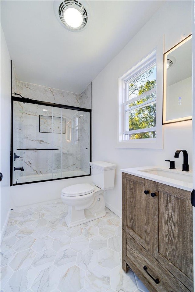 full bathroom featuring vanity, toilet, and enclosed tub / shower combo