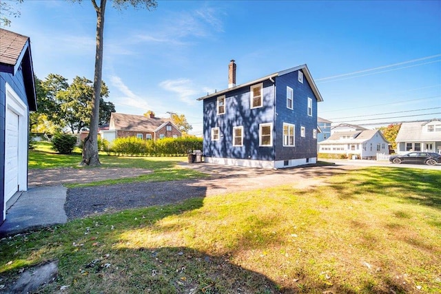 rear view of house with a yard