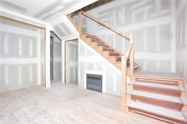 stairway featuring hardwood / wood-style floors