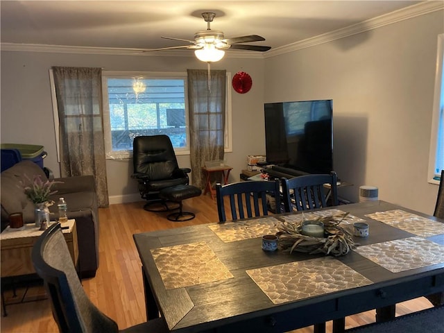 dining space featuring light hardwood / wood-style floors, ceiling fan, and crown molding