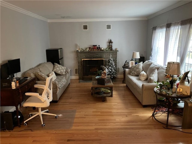 living room with light hardwood / wood-style floors and ornamental molding