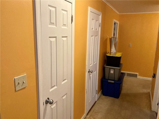 hallway featuring light colored carpet and ornamental molding