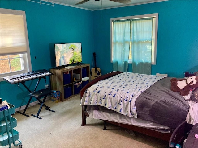 bedroom with carpet floors, ceiling fan, and crown molding