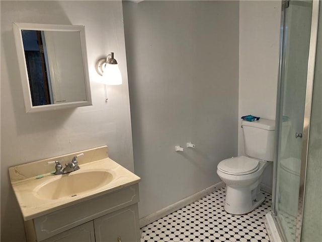 bathroom featuring tile patterned floors, vanity, an enclosed shower, and toilet