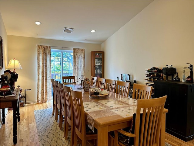 dining space with light hardwood / wood-style floors