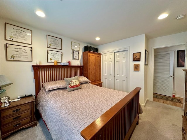 bedroom with light carpet and a closet