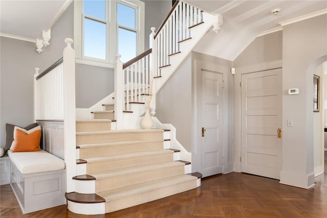 stairway featuring parquet floors and ornamental molding