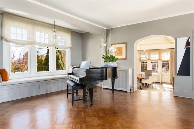 misc room with dark parquet floors, an inviting chandelier, and plenty of natural light