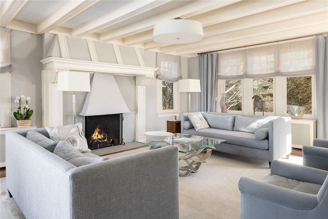 carpeted living room featuring beam ceiling, radiator heating unit, and a fireplace