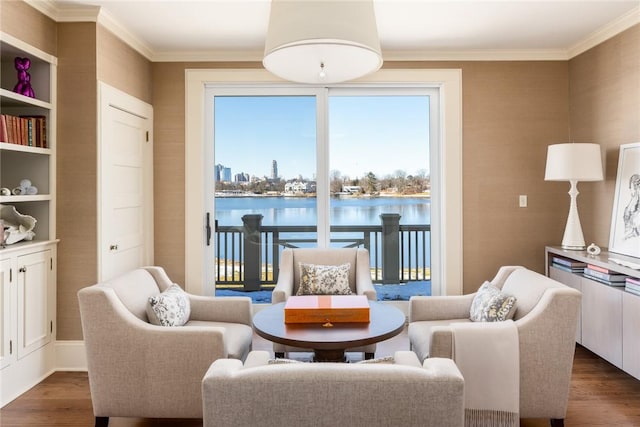 living area featuring a water view, dark hardwood / wood-style floors, and ornamental molding