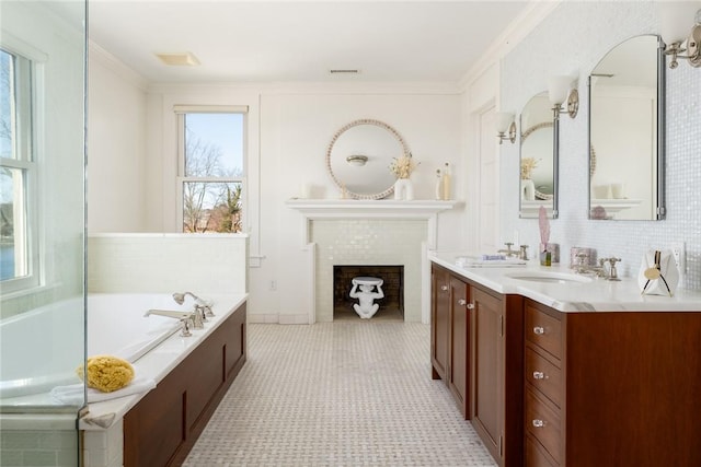 bathroom with a washtub, ornamental molding, vanity, and a brick fireplace