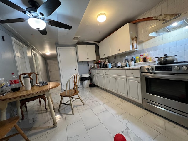 kitchen featuring stainless steel range with electric stovetop, exhaust hood, ceiling fan, tasteful backsplash, and white cabinetry