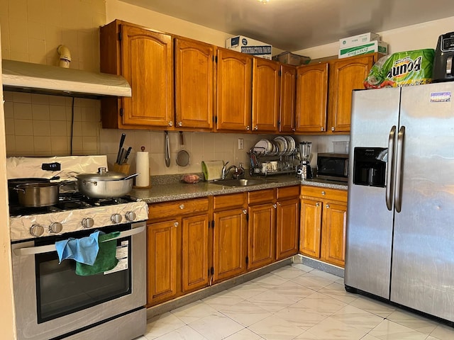 kitchen featuring backsplash, sink, and stainless steel appliances