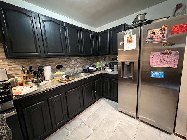 kitchen with backsplash, sink, light stone countertops, light tile patterned flooring, and stainless steel fridge with ice dispenser