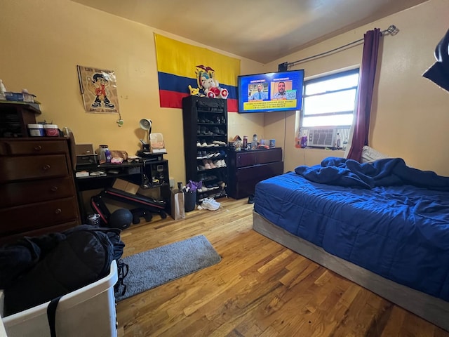 bedroom with light wood-type flooring and cooling unit