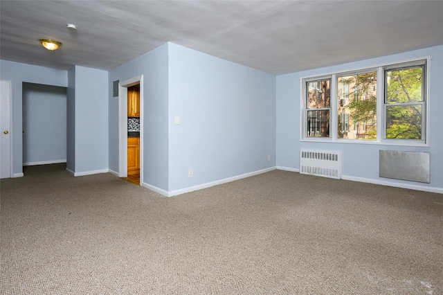 carpeted empty room with radiator