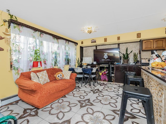 tiled living room featuring baseboard heating and a chandelier