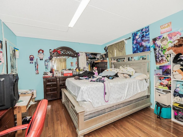 bedroom with dark hardwood / wood-style flooring