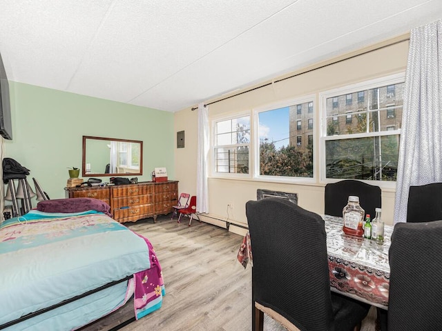 bedroom featuring a textured ceiling and light wood-type flooring