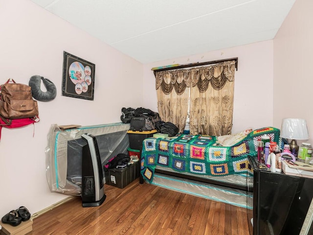 bedroom with hardwood / wood-style floors