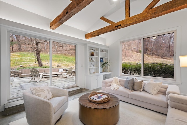 living room with beam ceiling, plenty of natural light, and high vaulted ceiling