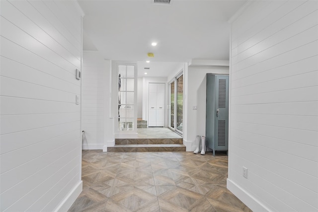 hallway featuring light parquet flooring