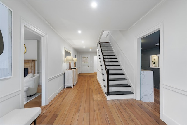 interior space with light hardwood / wood-style floors and ornamental molding