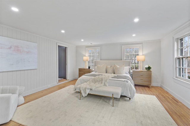 bedroom with light wood-type flooring and crown molding