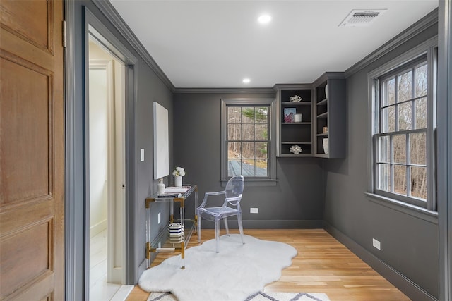 home office featuring light hardwood / wood-style flooring and ornamental molding