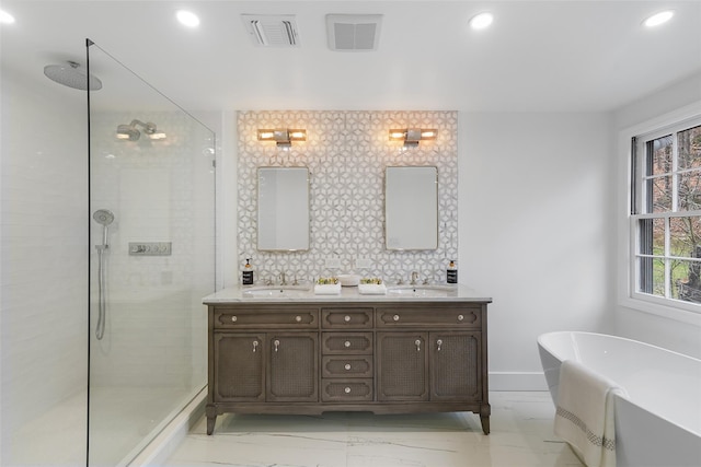 bathroom with vanity, separate shower and tub, and tasteful backsplash