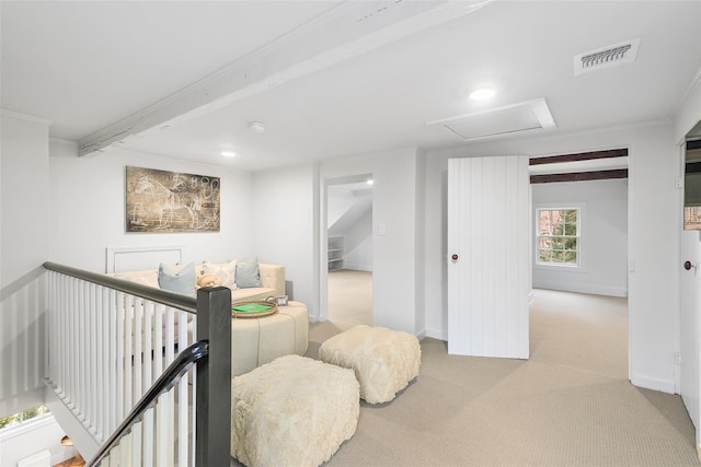 bedroom with beam ceiling, crown molding, and light carpet