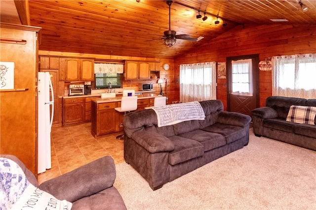 living room featuring light carpet, wood ceiling, vaulted ceiling, ceiling fan, and wooden walls