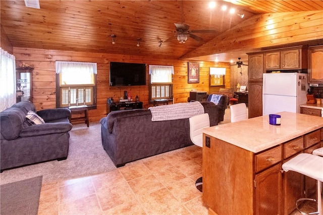 living room featuring light carpet, wood ceiling, ceiling fan, lofted ceiling, and wood walls