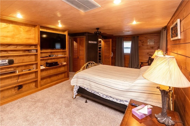 bedroom with carpet flooring, wooden walls, and wood ceiling