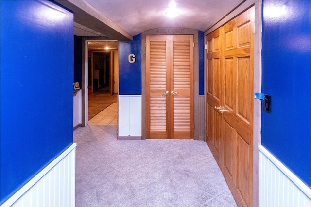 hallway with light colored carpet