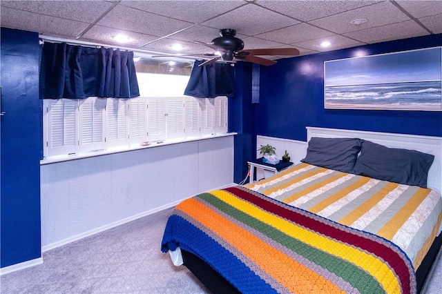 bedroom with a paneled ceiling and ceiling fan