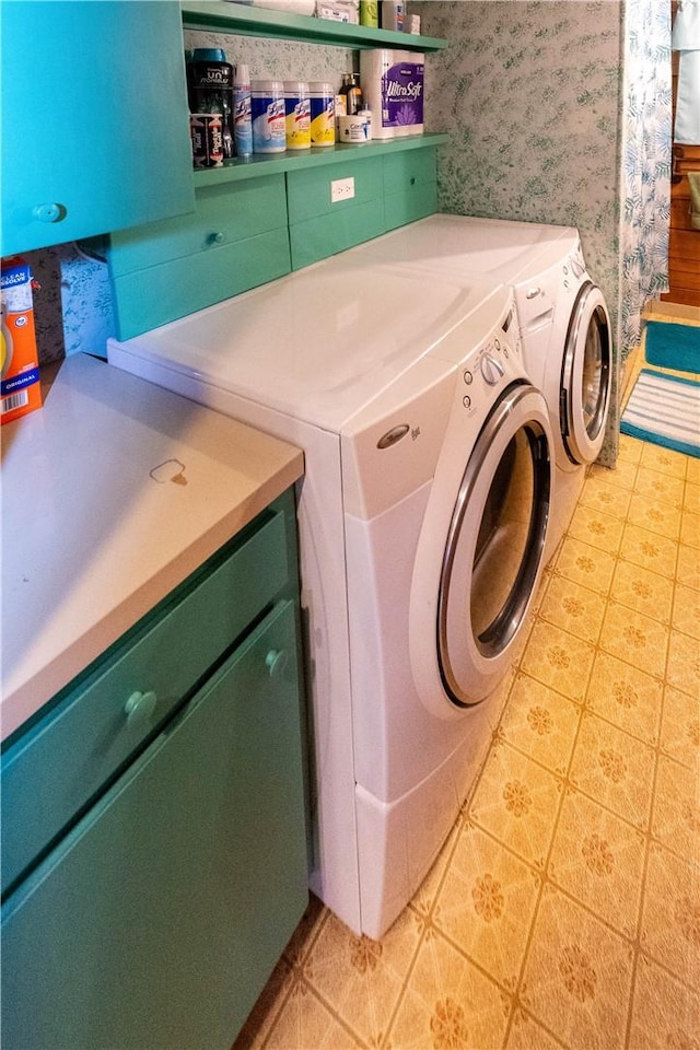 laundry area with cabinets and washing machine and clothes dryer