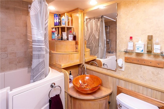 bathroom featuring shower / tub combo and toilet