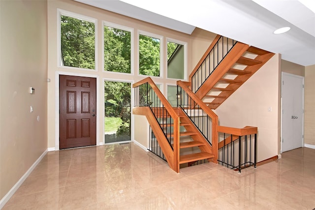 7 High Point Cir, Chappaqua, NY 10514 - entryway featuring plenty of natural light, baseboards, stairs, and a high ceiling