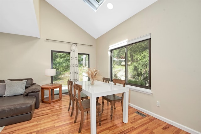 7 High Point Cir, Chappaqua, NY 10514 - dining area with light wood-style floors, high vaulted ceiling, french doors, a skylight, and baseboards
