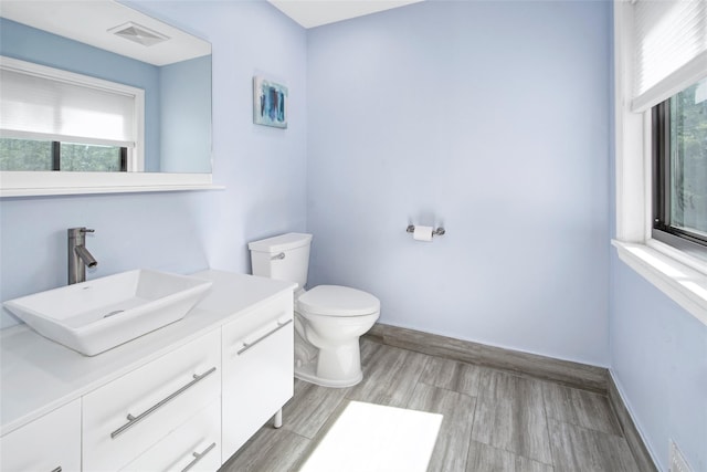 7 High Point Cir, Chappaqua, NY 10514 - bathroom with toilet, vanity, healthy amount of natural light, and baseboards