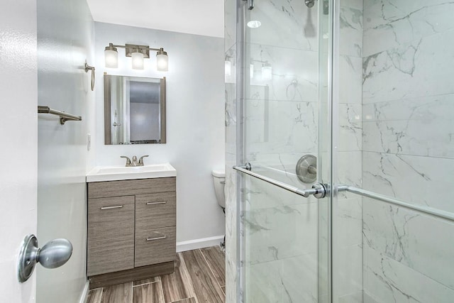 7 High Point Cir, Chappaqua, NY 10514 - full bath with a marble finish shower, vanity, wood finished floors, baseboards, and toilet