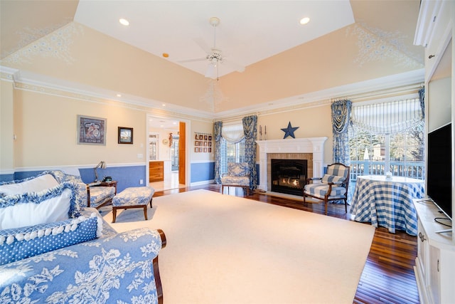 living room with dark hardwood / wood-style floors, ceiling fan, and a towering ceiling