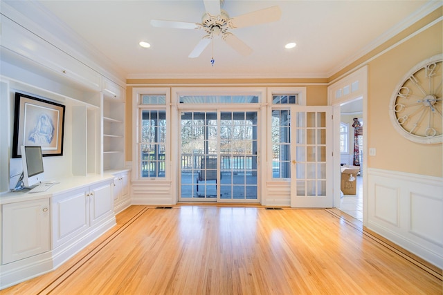 interior space with french doors, crown molding, ceiling fan, built in features, and light hardwood / wood-style floors