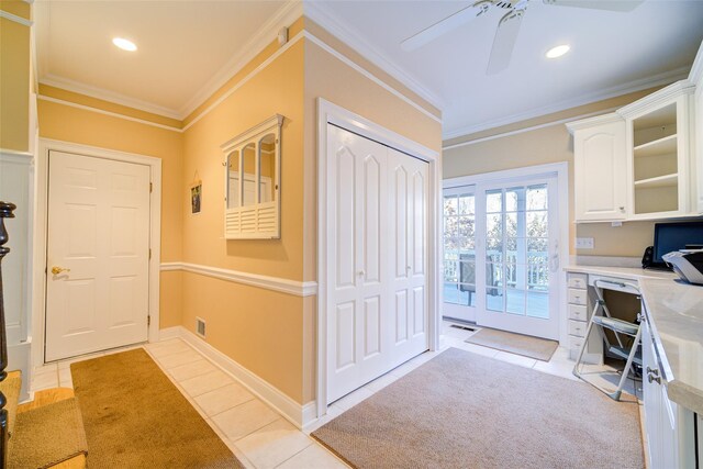 interior space featuring light tile patterned floors and crown molding