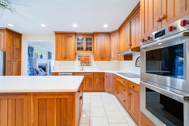 kitchen with ornamental molding, stainless steel appliances, ceiling fan, sink, and light tile patterned flooring